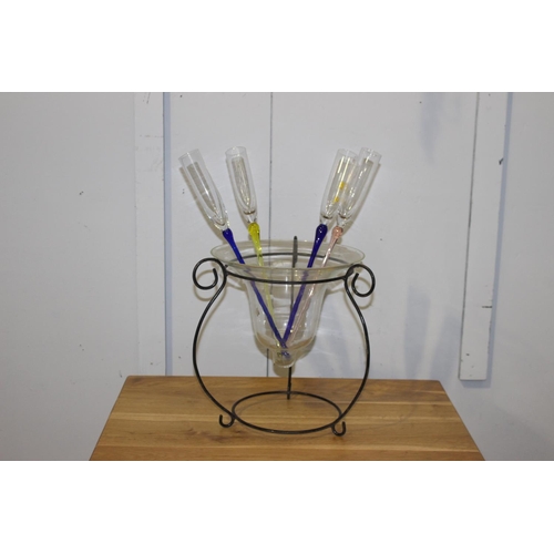 67 - Set of four champagne flutes in glass bowl on stand.