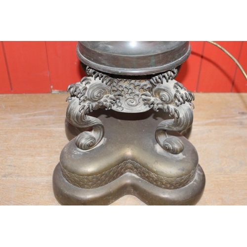 731 - Bronze table lamp in the form of a Japanese urn raised on three dolphin supports and platform base. ... 