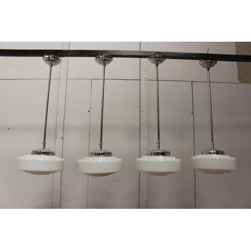 218 - Set of four chrome hanging lights with opaque glass shades {135 cm H x 30 cm Dia.}.