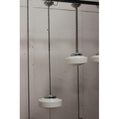 218 - Set of four chrome hanging lights with opaque glass shades {135 cm H x 30 cm Dia.}.