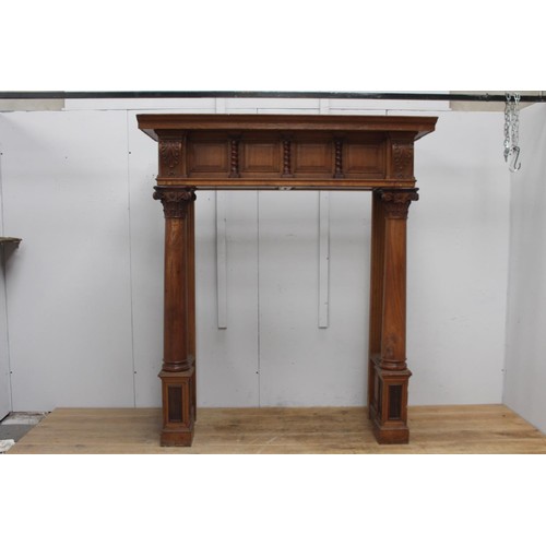 236 - Oak chimney piece decorated  with Corinthian columns {214 cm H x 184 cm W x 71 cm D}.