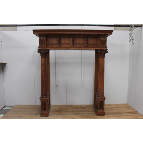 236 - Oak chimney piece decorated  with Corinthian columns {214 cm H x 184 cm W x 71 cm D}.