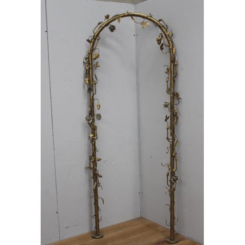 242 - Brass wedding arch with lights decorated with grapes and flowers {220 cm H x 90 cm W x 10 cm D}.