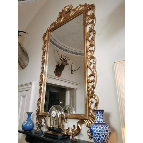 140 - Good quality carved giltwood overmantel mirror in the Rocco manner {260 cm H x 135 cm W}.