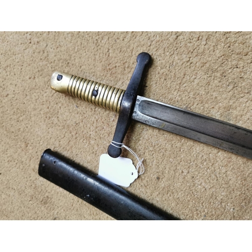 147 - 20th C. French bayonet in original scabbard with brass hilt {72 cm L}.