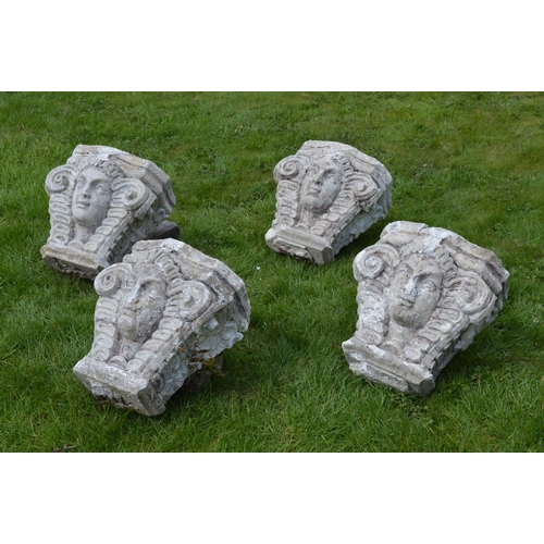 18 - Set of four carved stone capitals {50 cm H x 42 cm W}.