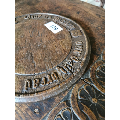 189 - 19th C. oak bread board carved with Give Us This Day Our Daily Bread and oak leaf {25 cm Dia.}.