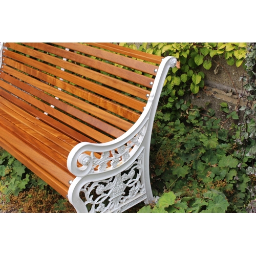 19 - Decorative cast iron garden seat with wooden slats { 88cm H X 154cm W X 48cm D }.