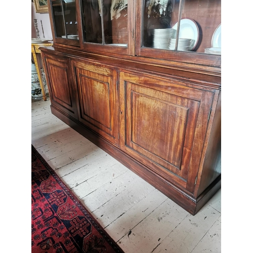 202 - Georgian mahogany bookcase with three long glazed doors over three panelled doors {251 cm H x 211 cm... 