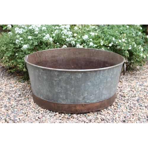 26 - Metal planter of round form with handles { 26cm H X 60cm Dia }.