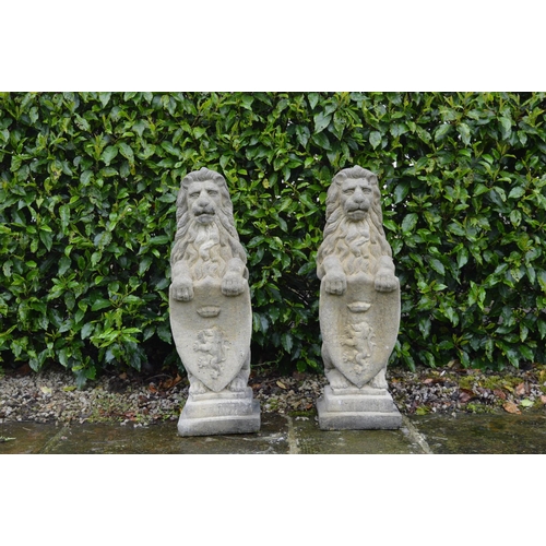 38 - Pair moulded stone Lions with shields {85 cm H x 25 cm W}.