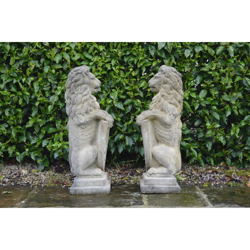 38 - Pair moulded stone Lions with shields {85 cm H x 25 cm W}.