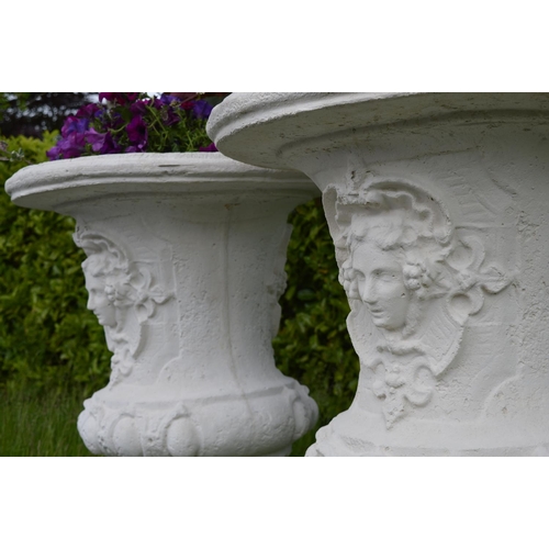 6 - Pair large moulded stone urns decorated with ladies masks {132 cm H x 80 cm Dia.}.