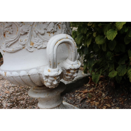 7 - Pair of cast iron urns decorated with faces and acanthus leaves { 75cm H X 65cm Dia }.