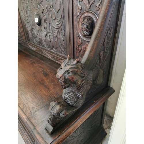 99 - 19th. C. carved oak monk's bench the arm rests terminating in dog's heads { 118cm H X 136cm W X 45cm... 