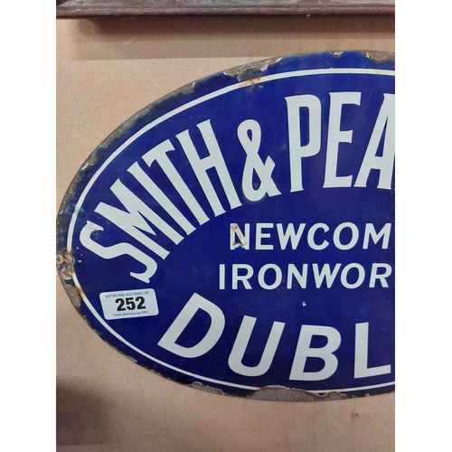 252 - Smith and Pearson Ltd Newcomen Ironworks Dublin oval enamel advertising sign. {46 cm W}.