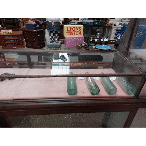 265 - Early 20th C. mahogany and glass counter display cabinet. {69 cm H x 240 cm W x 41 cm D}.