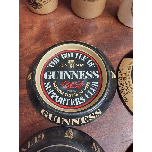 270 - Four tinplate Guinness ashtrays. {15 cm Dia}.