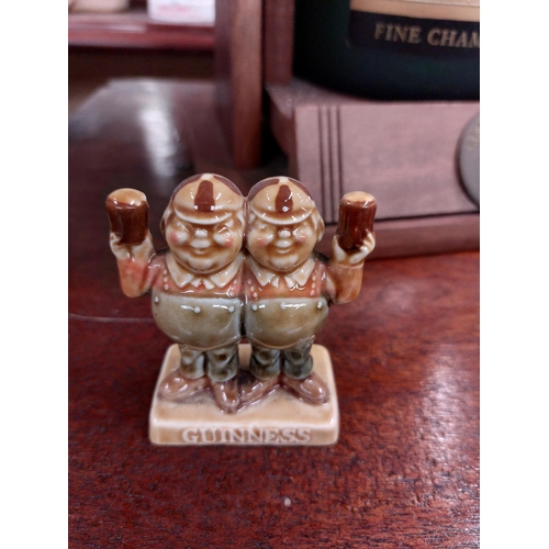 295 - Two Guinness ceramic advertising figures {8 cm H}.