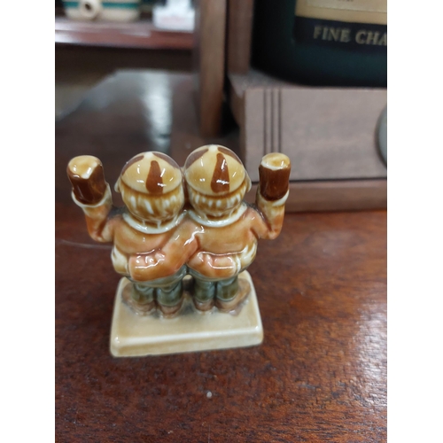 295 - Two Guinness ceramic advertising figures {8 cm H}.