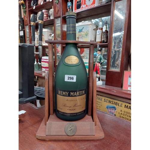 296 - Remy Martin Brandy Bottle in wooden cradle. {52 cm H x 18 cm W x 19 cm D}.