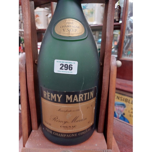 296 - Remy Martin Brandy Bottle in wooden cradle. {52 cm H x 18 cm W x 19 cm D}.