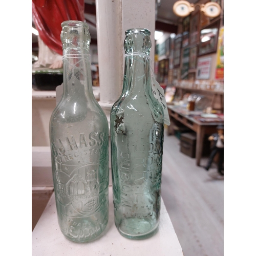 299a - Two 19th C. glass bottles - C J Hassett Ennis and Hovenden and Orr Ltd Dublin. {22 cm H x 6 cm Dia}.