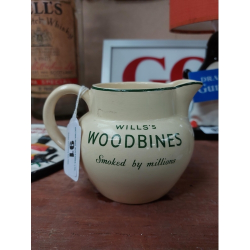 91 - Wills's Woodbine  ceramic water jug. {10 cm H x 15 cm W x 12 cm D}.