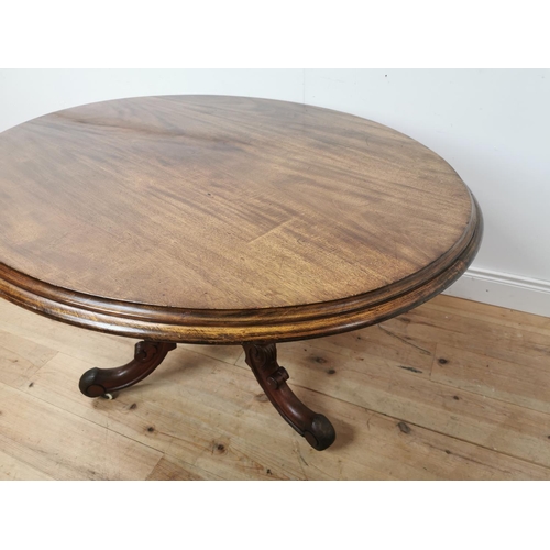 1014 - 19th. C. mahogany breakfast table the oval top raised on turned column and three outswept feet { 75c... 