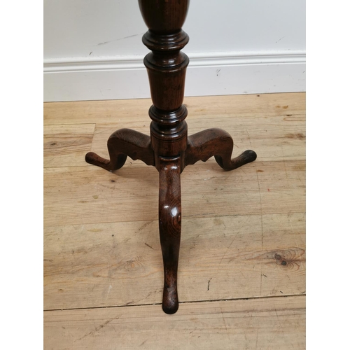 105 - 18th C. oak wine table raised on turned column and three outswept feet {73 cm H x 39 cm Dia.}.