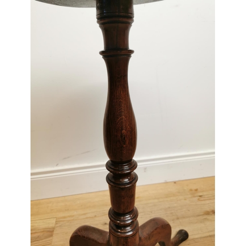 105 - 18th C. oak wine table raised on turned column and three outswept feet {73 cm H x 39 cm Dia.}.