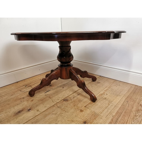 1068 - Mahogany and inlaid satinwood coffee table with shaped top on turned column on four outswept feet. {... 