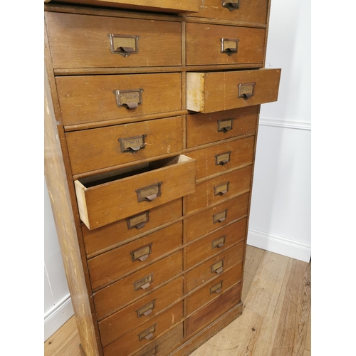 11 - Early 20th. C. painted pine bank of twenty five short drawers with original handles, raised on plint... 
