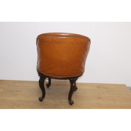 117 - Leather upholstered mahogany swivel tub chair raised on cabriole legs { 86cm H X 56cm W X 77cm D }