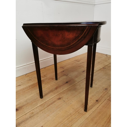 120 - Mahogany drop leaf lamp table with inset leather top raised on square reeded legs in the Georgian ma... 