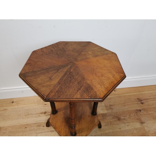 125 - Edwardian oak lamp table with segment top raised on turned columns and platform base {69 cm H x 48 c... 