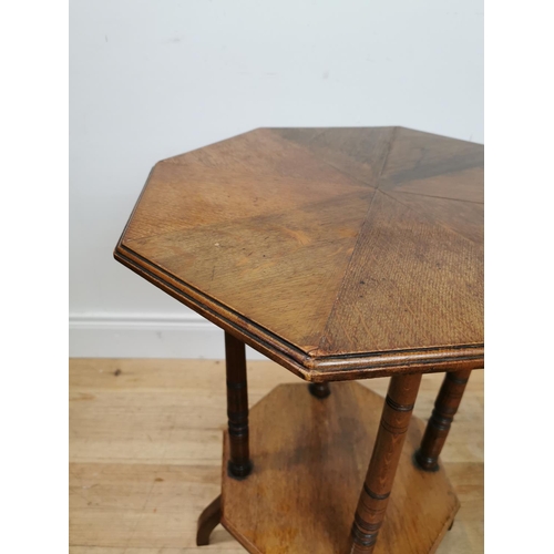 125 - Edwardian oak lamp table with segment top raised on turned columns and platform base {69 cm H x 48 c... 