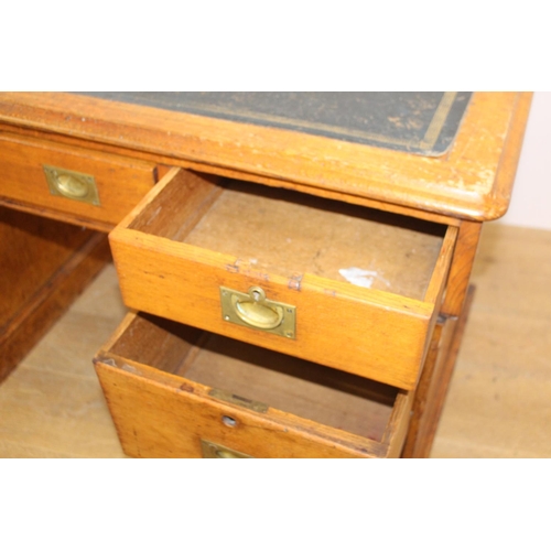 126 - 19th. C. oak knee hole writing desk the tooled leather top above a long drawer flanked by six gradua... 
