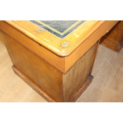 126 - 19th. C. oak knee hole writing desk the tooled leather top above a long drawer flanked by six gradua... 