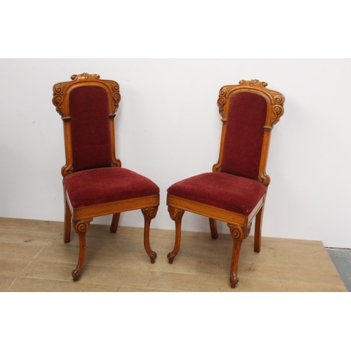 141 - Pair of upholstered oak hall chairs raised on shaped legs { 110cm H X 51cm W X 45cm D }.