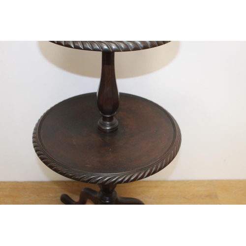 239 - Mahogany three tier dumb waiter raised on three outswept legs { 102cm H X 38cm Dia }.