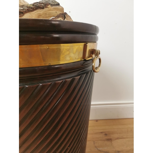 261 - Brass bound mahogany peat bucket in the Irish Georgian style { { 66cm H X 53cm Dia }.