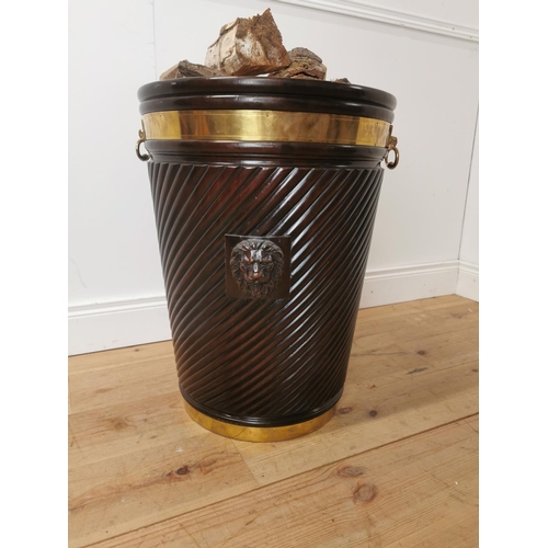 261 - Brass bound mahogany peat bucket in the Irish Georgian style { { 66cm H X 53cm Dia }.