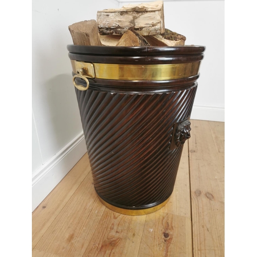 261 - Brass bound mahogany peat bucket in the Irish Georgian style { { 66cm H X 53cm Dia }.