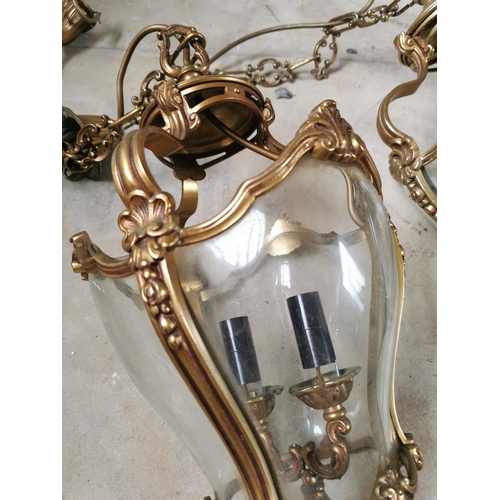 265 - Pair of decorative brass and glass hanging lanterns { 70cm H X 25cm Dia }.