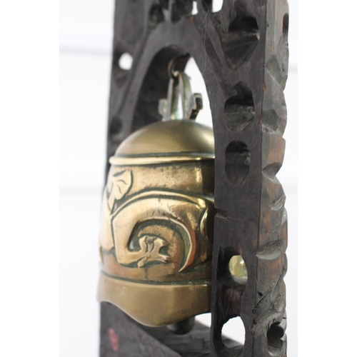 268 - Tibetian brass bell in wooden frame { 35cm H X 20cm W X 10cm D }.