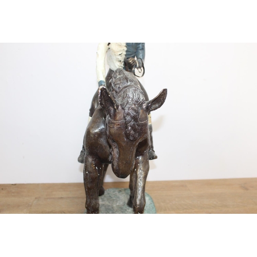 283 - Bronze model of a horse and jockey { 102cm H X 38cm W X 104cm D }..