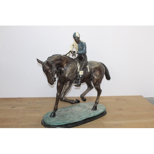 283 - Bronze model of a horse and jockey { 102cm H X 38cm W X 104cm D }..