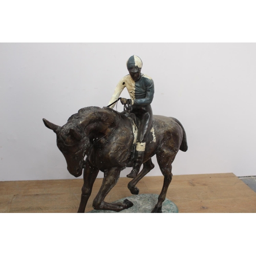 283 - Bronze model of a horse and jockey { 102cm H X 38cm W X 104cm D }..