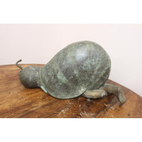 284 - Bronze model of a baby in a snail shell { 25cm H X 62cm W X 17cm D }.